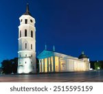 Illuminated Cathedral Square with Vilnius Cathedral and bell tower at night. Sightseeing, chill destinations travel trend . Lithuania. Place for text