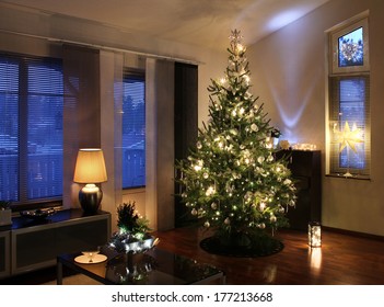 Illuminated Christmas Tree Decorated In Modern Living Room