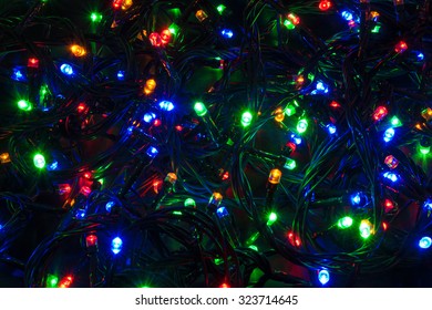 Illuminated closeup of tangled Christmas lights