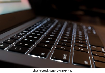 illuminated computer keyboard in the dark. selective focus
