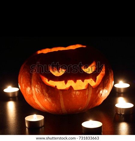 Similar – Image, Stock Photo Creepy carved Halloween pumpkin next to burning candle