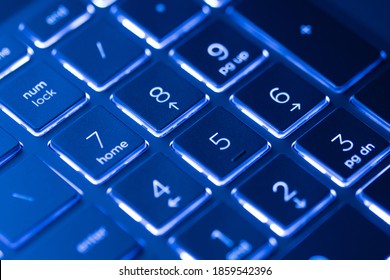 Illuminated, Defocused Laptop Keyboard. Informatics Background.