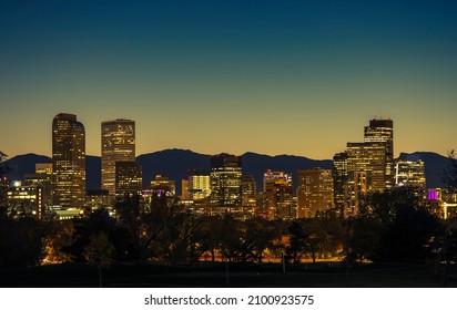 Illuminated Denver Downtown Towers And Front Range Mountains In A Background. Denver Colorado Skyline At Dusk