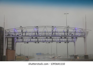 Illuminated Electronic Toll Gantry Over The Highway On A Rainy Day, Johannesburg South Africa