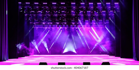 Illuminated empty concert stage with purple light and stage fog