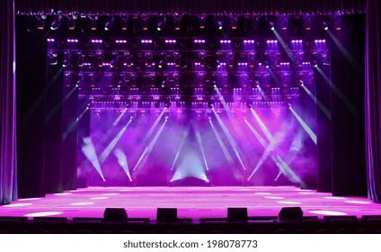 Illuminated Empty Magenta Concert Stage With Fog And Rays Of Light