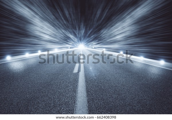 Illuminated empty night\
road. Forward\
concept