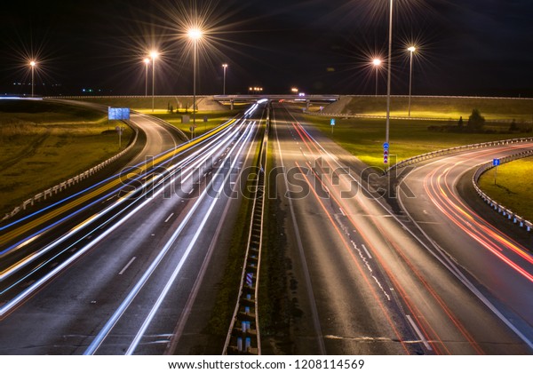 Illuminated highway\
road with car light\
trails