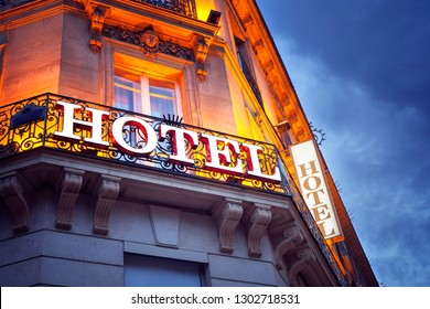 Illuminated hotel sign in Paris at night concept for vacation accomodation and business travel