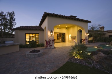 Illuminated House Exterior Against Clear Sky At Twilight