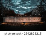 The illuminated Indiana University South Bend sign under a dramatic sky