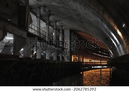 Illuminated industrial concrete tunnel perspective, abandoned underground submarine base from USSR period located in Balaklava, Crimea