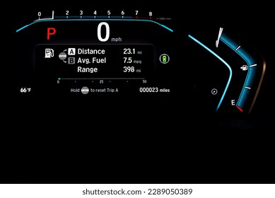 Illuminated instrument panel dashboard on new car with very low milage at only 23 miles odometer, digital display of gauges and indicators, fuel level, engine temperature. Modern driving technology - Powered by Shutterstock - Get 15% off with code: PIKWIZARD15