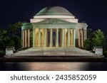 illuminated Jefferson Memorial at night.