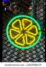 Illuminated Lemon. Bright colored collection of symbols or sign boards glowing with colorful neon light for cafe, restaurant, motel or cocktail bar. Template layout on grid background, copy space.