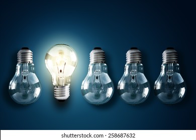 Illuminated light bulb in a row of dim ones concept for creativity, innovation and solution - Shutterstock ID 258687632