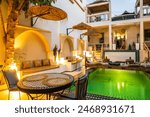 Illuminated with lights courtyard with swimming pool of traditional riad guesthouse in the evening in Taroudant town in Atlas Mountains, Morocco, North Africa