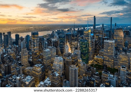 An illuminated midtown of New York City  and rainy clouds above in sunset. 