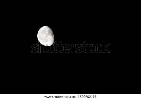illuminated moon\
in empty black autumn sky in\
night