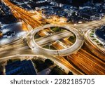 A illuminated multilevel highway junction interchange during night time with blurred car traffic as seen in Athens, Greece