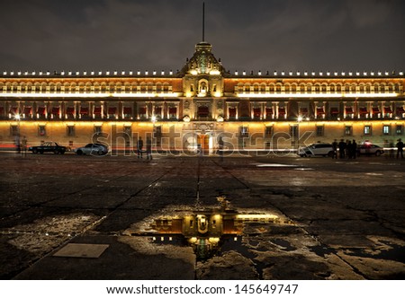 Illuminated National Palace in Plaza de la Constitucion of Mexico City at Night. Zocalo and Army Square are among other local names of this place.
