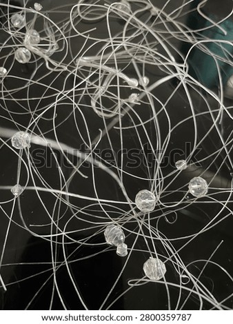 Illuminated neural network visualization on dark background — white nodes and connecting lines forming an intricate web of pathways, evoking synaptic connections or data flow in a complex system.