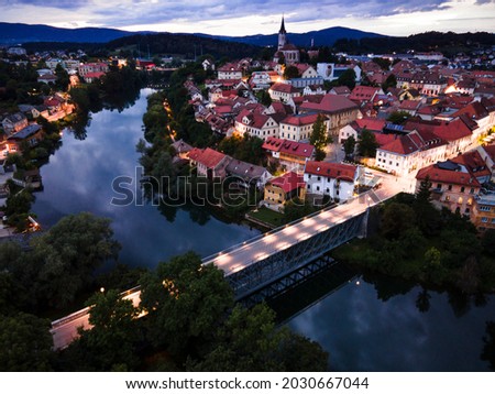 Illuminated at Night Novo Mesto in Lover Carniola Region in Slovenia at River Krka Bend. Drone View.