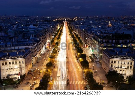 Champs-Élysées illuminated at night in Paris. 