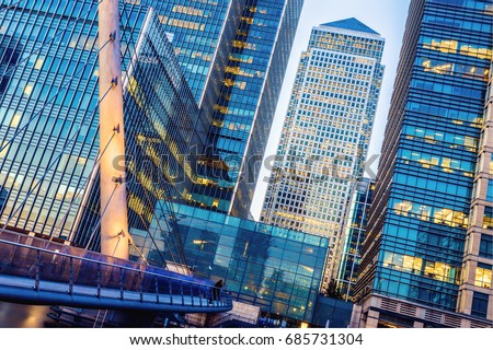 Illuminated office building and South Quay footbridge in Canary Wharf, London