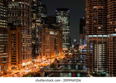 Illuminated Panorama Cityscape Of Chicago Downtown And River With Bridges At Night, Chicago, Illinois, USA. A Vibrant Business Neighborhood