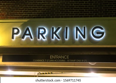 Illuminated Parking Sign Letters On The Outside Of Parking Lot Garage Structure In City's Downtown