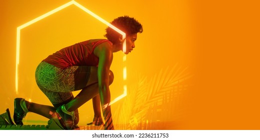 Illuminated plants and hexagon over african american female athlete crouching at starting position. Copy space, sprinting, sport, competition, running, racing, shape, nature and abstract concept. - Shutterstock ID 2236211753