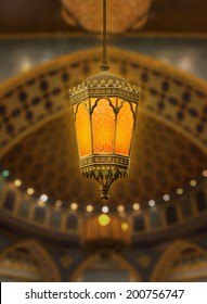 An Illuminated Ramadan Lantern Against Islamic Architecture