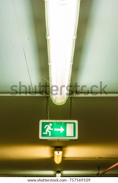 Illuminated\
sign on the ceiling shows the emergency\
exit