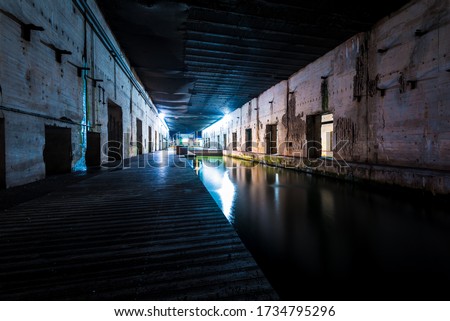Illuminated submarine base of Saint-Nazaire at night, France. Travel destinations, sightseeing, history, World War II theme