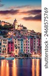 Illuminated summer cityscape of Portovenere port. Picturesque sunset in Liguria, province of La Spezia, Italy, Europe. Fantastic seascape of Mediterranean sea. Travel the world.
