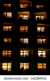 Illuminated Windows Of A House At Night