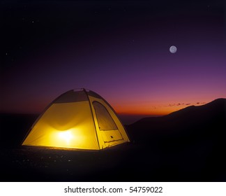 Illuminated Yellow Camping Tent At Night