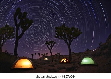 Illuminous Light Painted Landscape Of Camping And Stars In Joshua Tree National Park