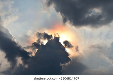  illustrated tropical hot afternoon sun behind dark clouds as natural background