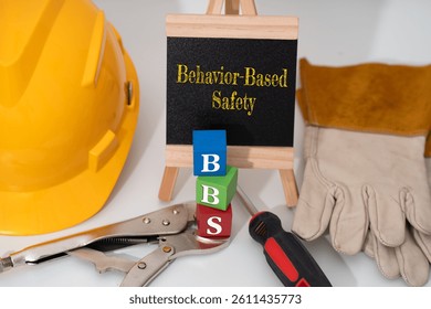 Illustration for Behavior-Based Safety (BBS) featuring safety helmet, screwdriver, hand glove and Locking Plier Curve Jaw, and three block cube with text BBS 