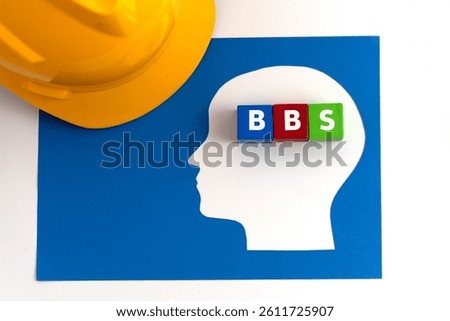 Illustration for Behavior-Based Safety (BBS) featuring safety helmet along with  a paper-cut human head with blue, red and green blocks, labeled BBS