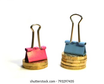 Illustration Of Gender Pay Gap Using Blue And Pink Bulldog Clips With Pound Coins, Blue Clip On Stack Of Four Pound Coins, Pink Clip On Stack Of Two Pound Coins