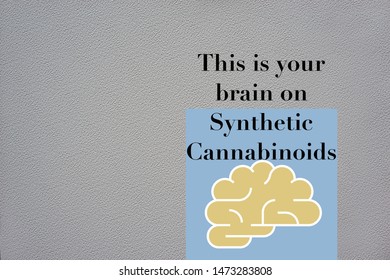 An Illustration And Graphic Design Of A Human Brain. This Is Your Brain On Synthetic Cannabinoids With An Icon Symbol Of The Mind On A Grey Textured Background.