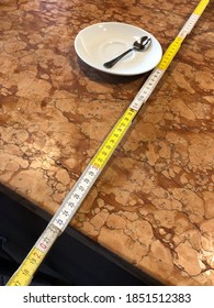 Illustration Of How Social Distancing Is Measured At Some Cafes And Bars In Italy, Using A Metre Ruler From The Edge Of The Counter To Show How Far Away A Customer Has To Stand