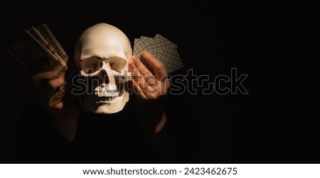Illustration to Latin sentence: Thus passes the glory of the world (Sic transit gloria mundi). Skull with money and game cards against black background. Copy space. Stock photo © 