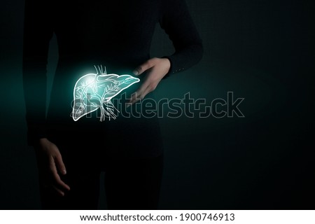 Illustration of liver detox with highlighted organ and contrast hands on dark background. Low key photo with copy space toned in dark green colors. 