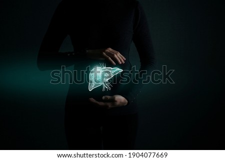 Illustration of liver detox with highlighted organ and contrast hands on dark background. Low key photo with copy space toned in dark green colors. 