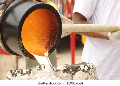 Illustration Of Molten Metal  Being Poured From A Foundry Crucible Statue