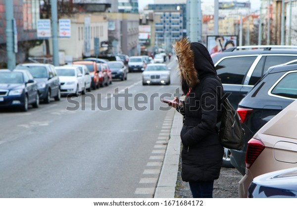 Illustration of the problem of the modern age.\
Called digital zombie. People are watching their smart phone with\
headphones and don´t pay\
attention